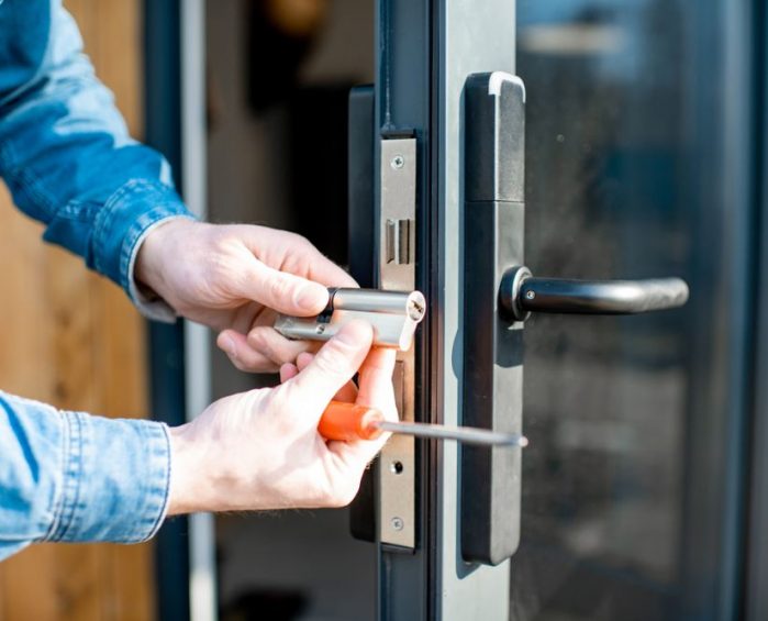 Man Changing Door Lock — Security Door Screen in Laidley, QLD